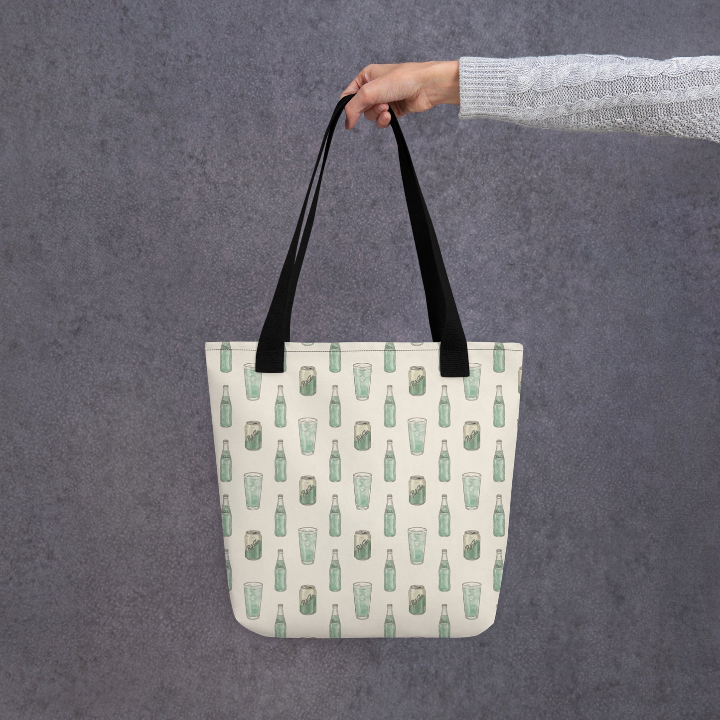 Hand holding tote bag with Pakola Pakistani green soda inspired print