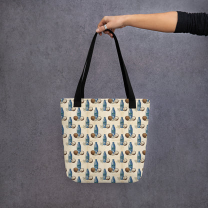 Hand holding tote bag with tail malish coconut oil inspired print 